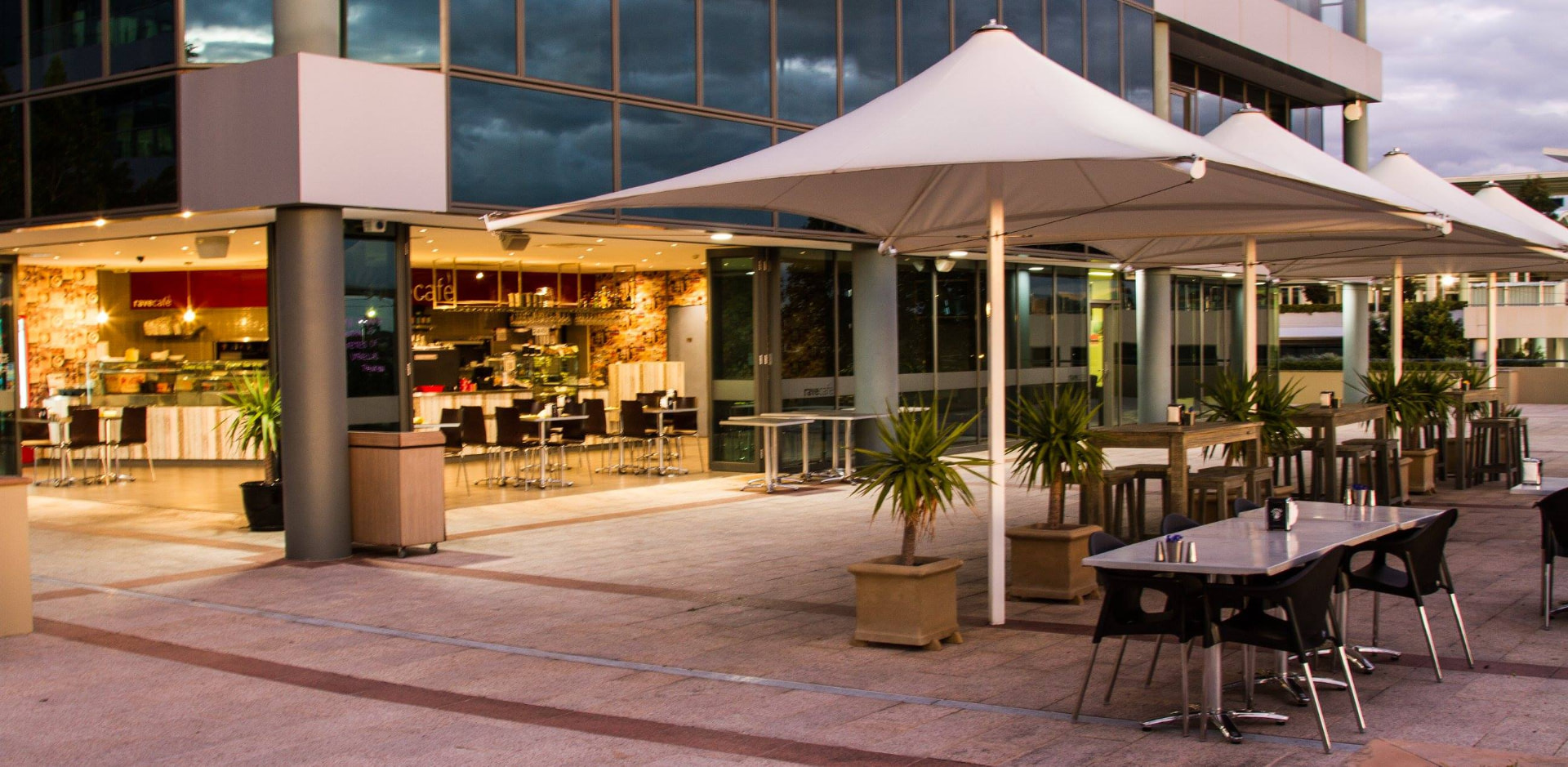 Terrace plaza with fountain and white umbrellas