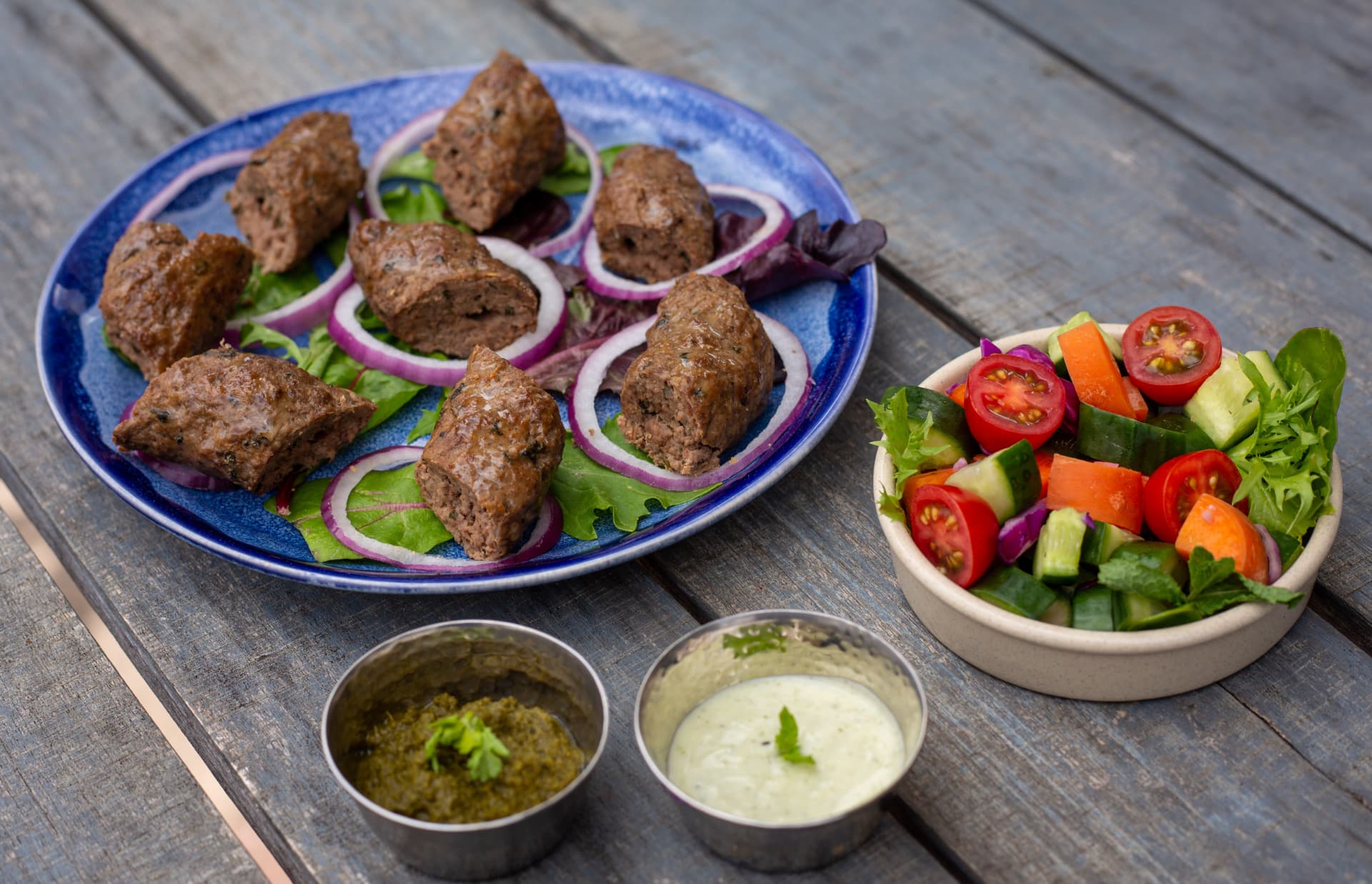 Original photograph of Seekh Patiala Shahi lamb kebabs with chutneys and salad