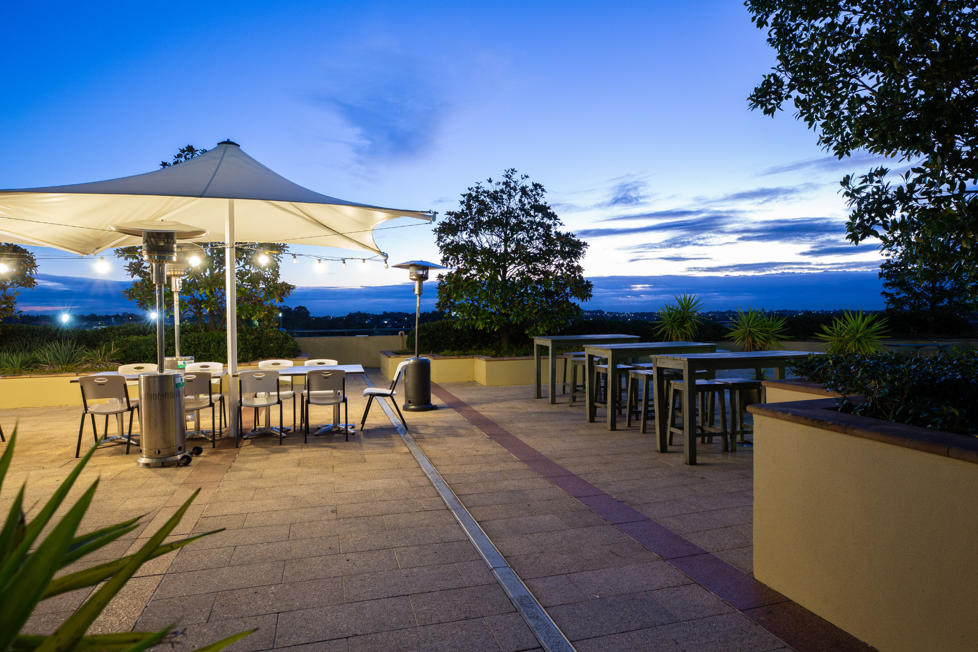 Terrace seating under a blue evening sky