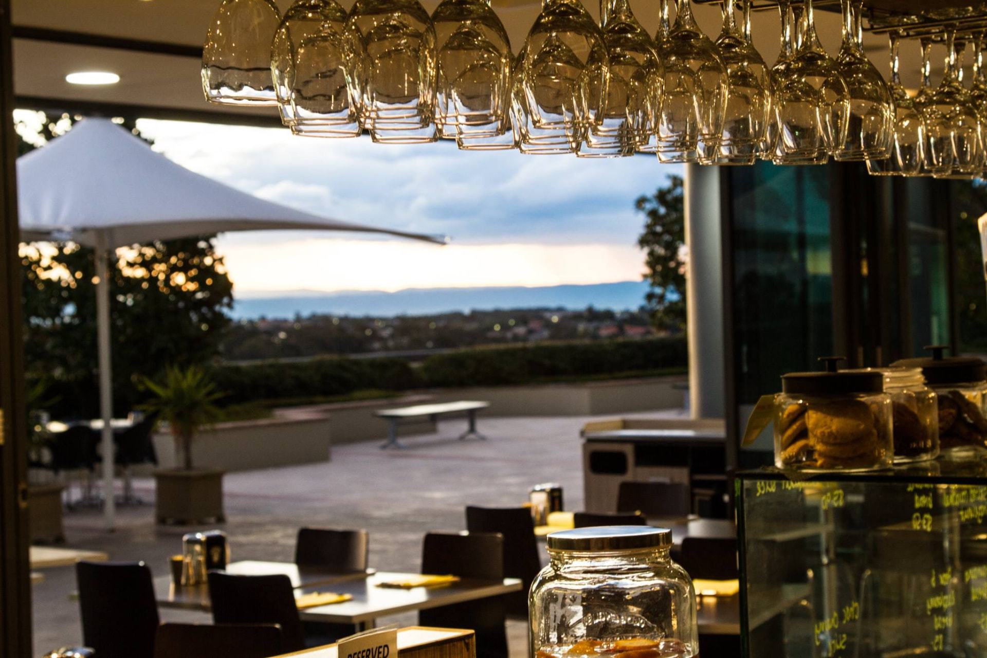View from the bar through hanging glasses to the terrace