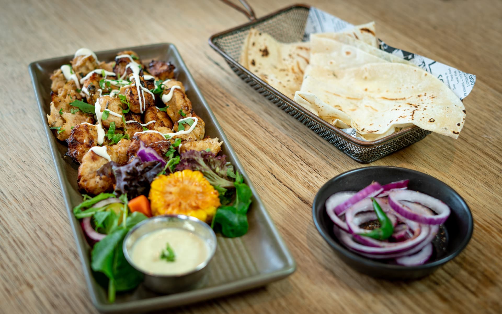 Original photograph of Shikhampuri Kebab with cream drizzle and naan
