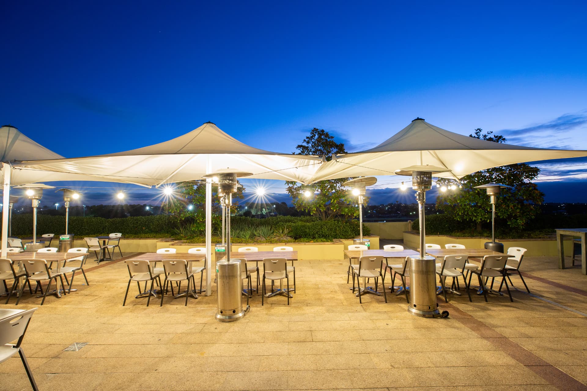 Terrace canopies and heaters at blue hour