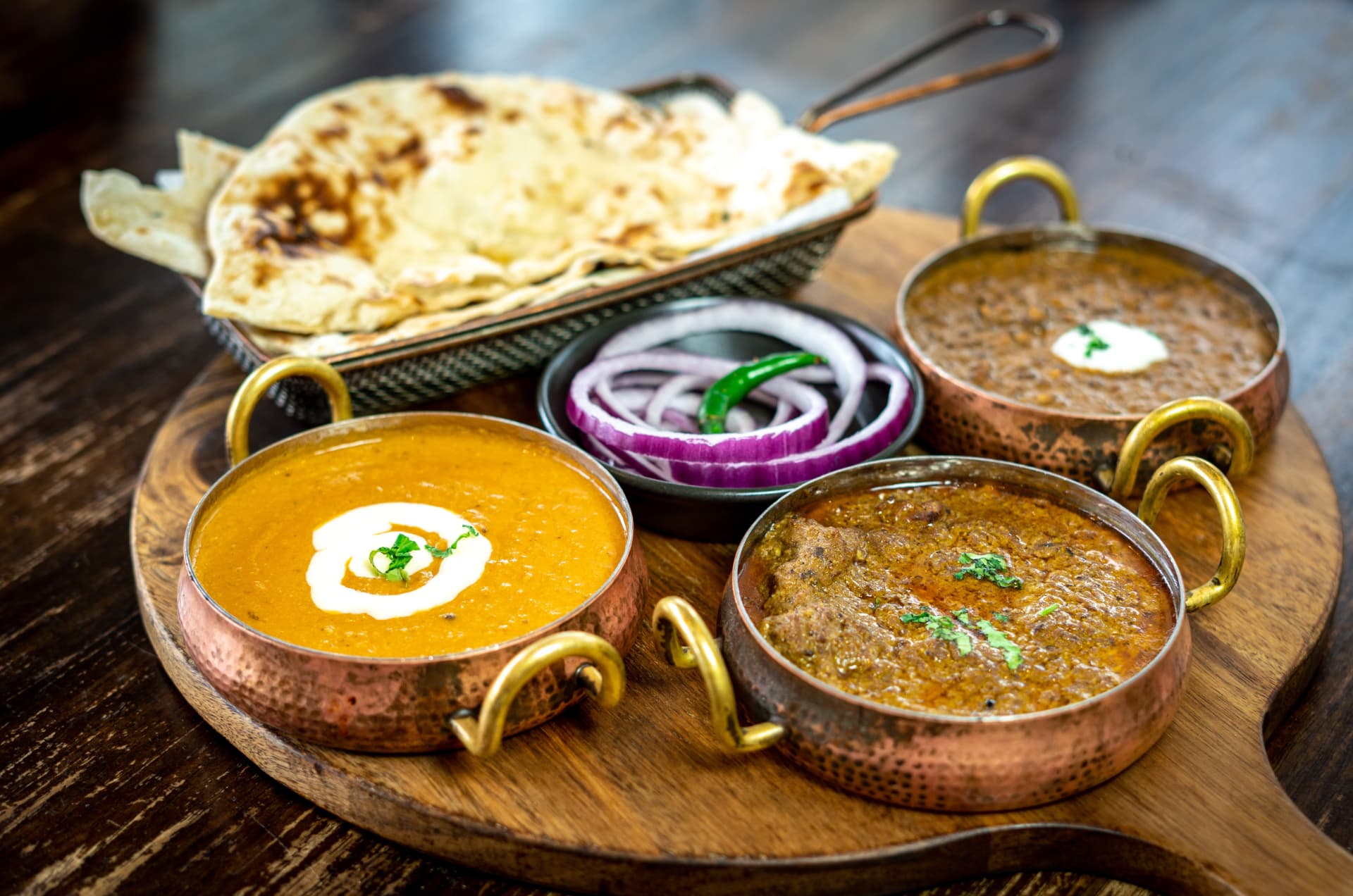 Original photograph of the Kebabiya Curries Sampler with three curries in copper bowls