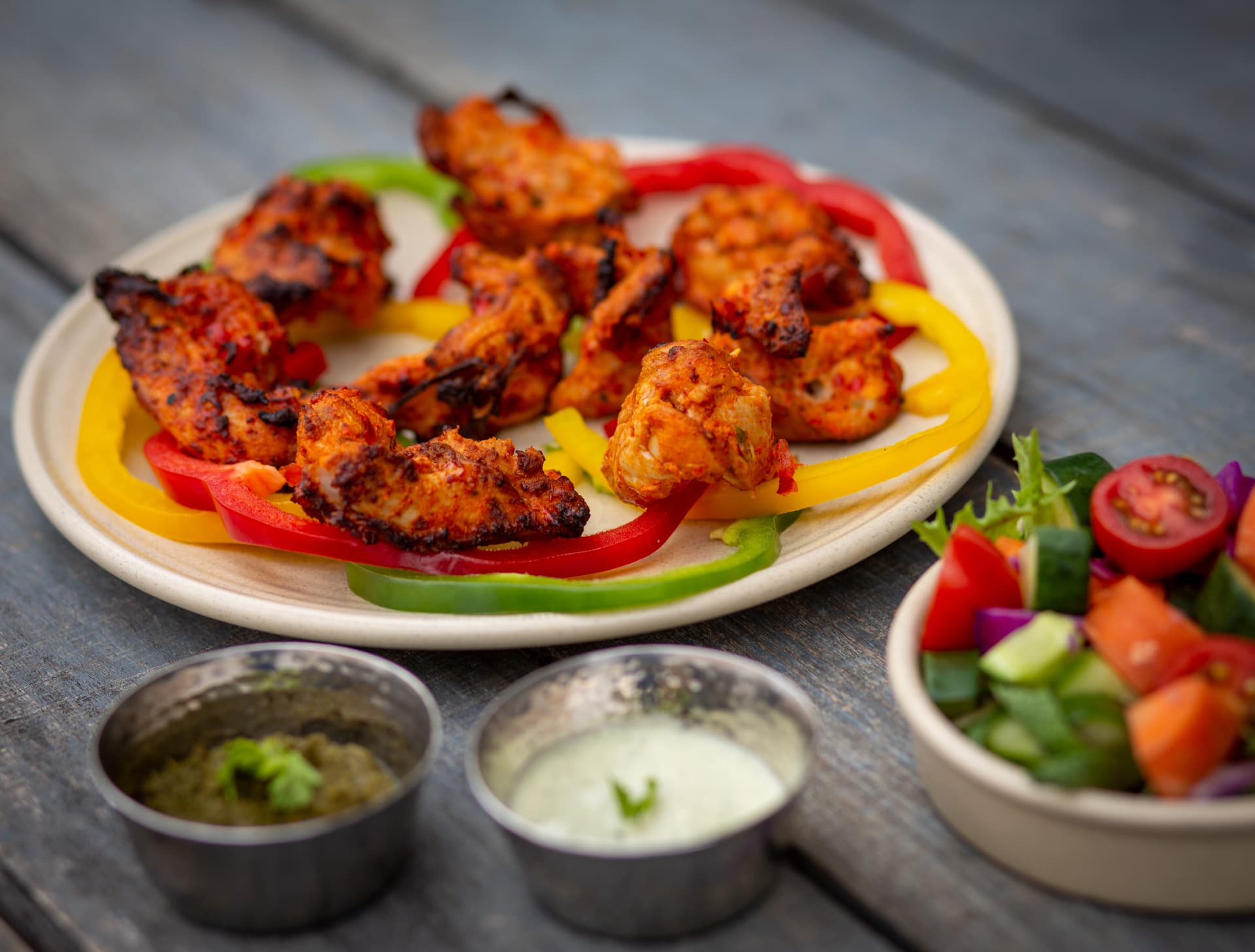 Original photograph of Abeer-e-Surkh chicken tikka with peppers and chutneys
